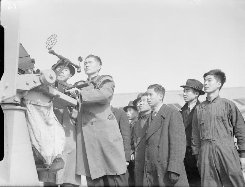 Black-and-white wartime photograph of Chinese merchant seamen in Liverpool learning to operate an Oerlikon anti-aircraft gun.