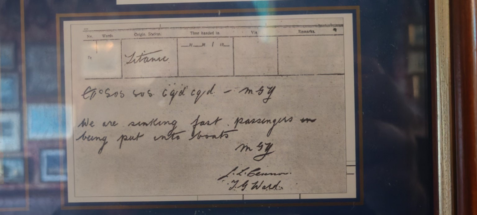Display reproduction of Titanic’s handwritten wireless message saying the ship was sinking fast.